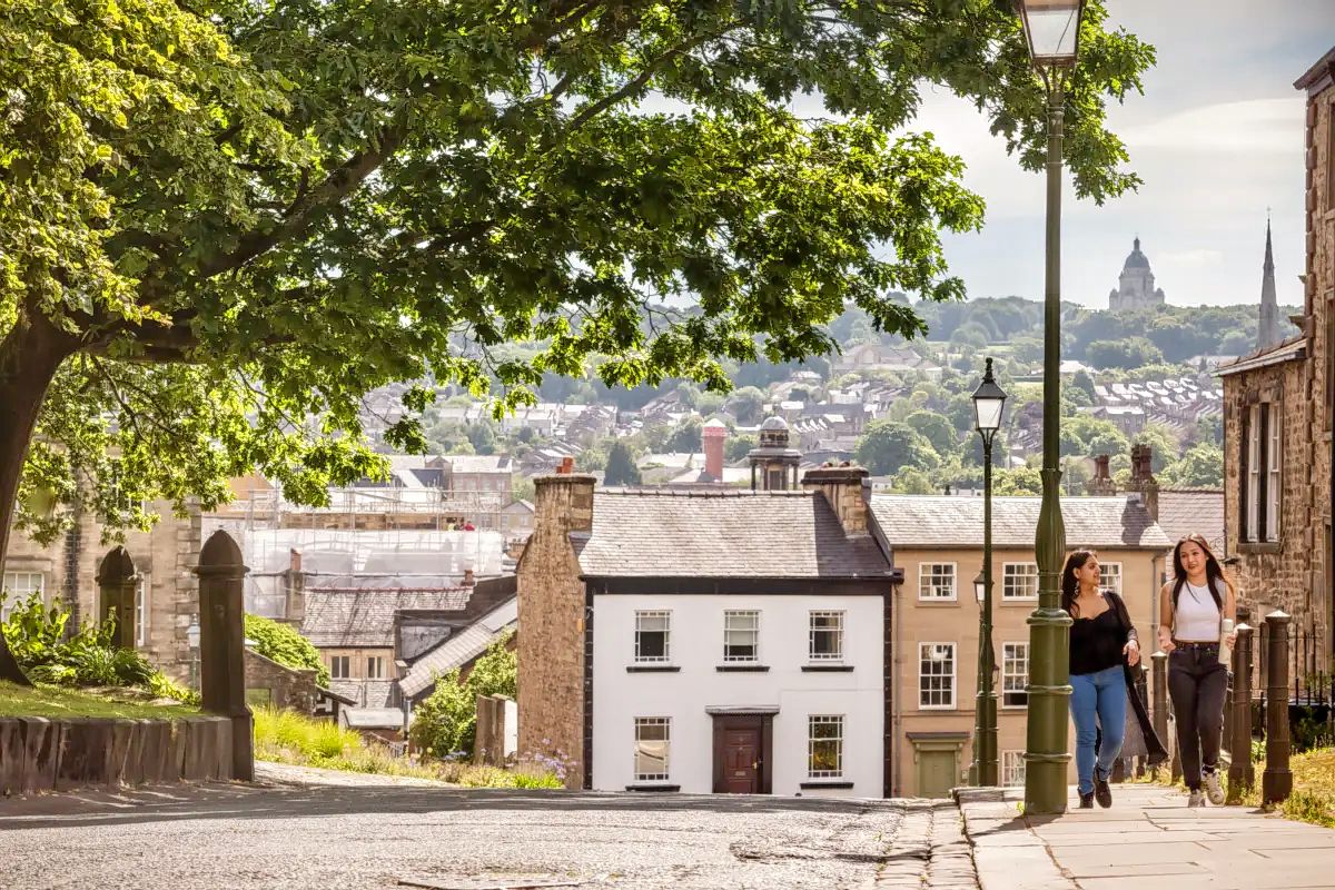 Two students walk through Lancaster's historic streets.