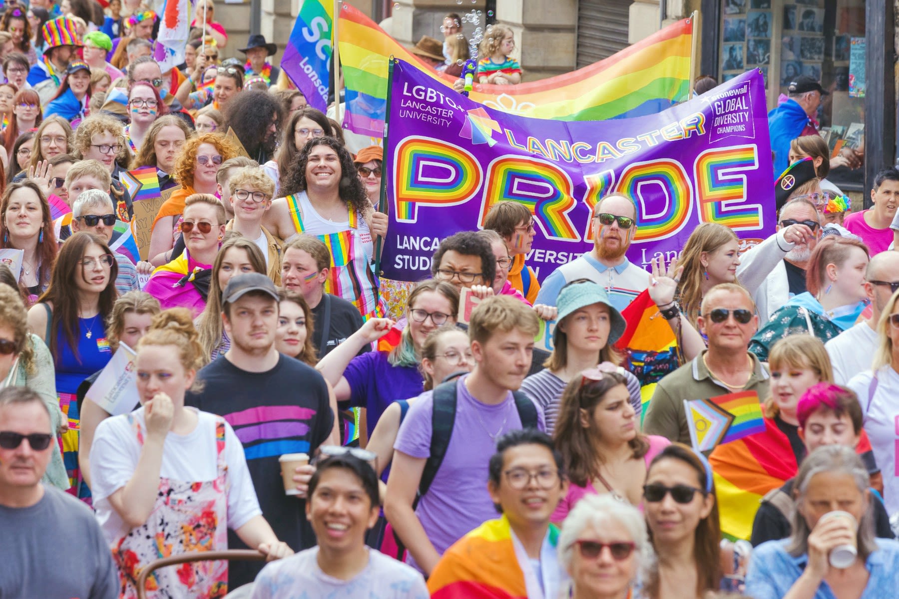 A large crowd of people take part in Lancaster Pride.
