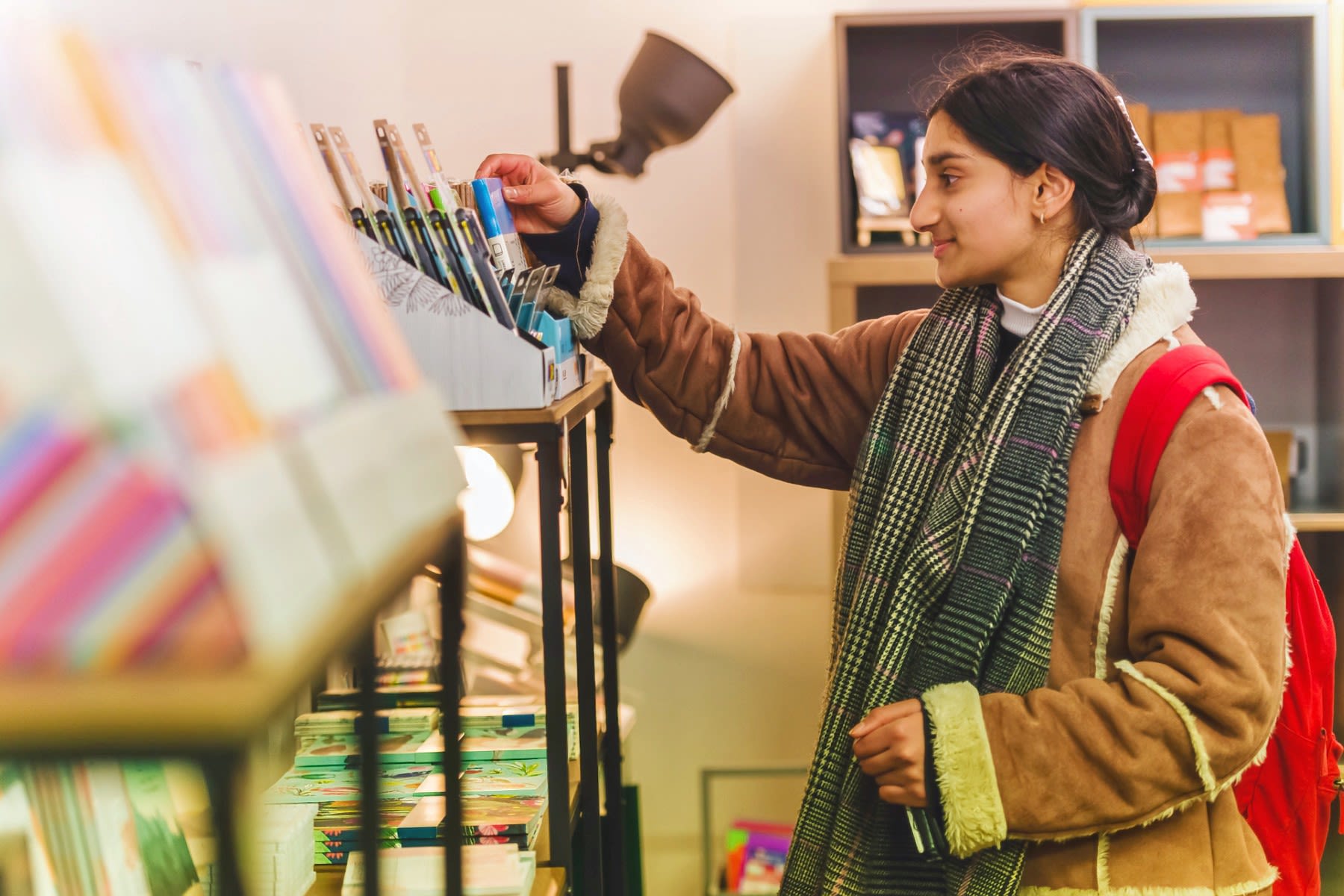 A student browses for art supplies in a boutique.