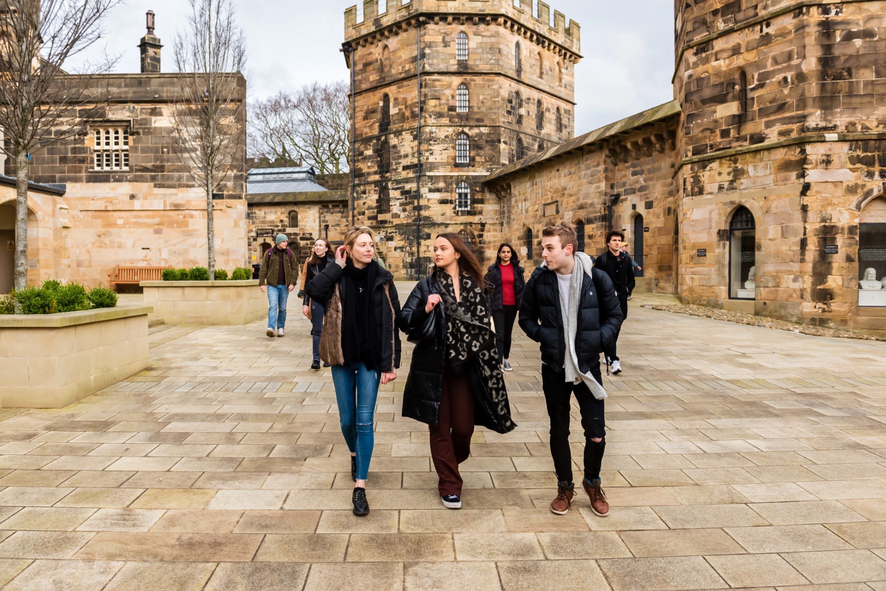 Students walk around Lancaster Castle courtyard.
